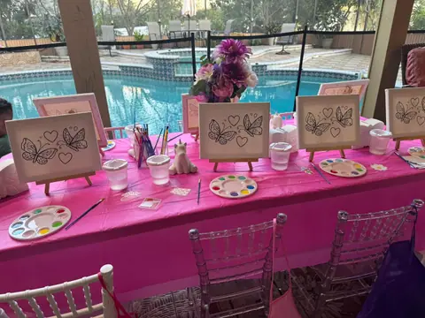 Poolside painting party table with canvases and palettes