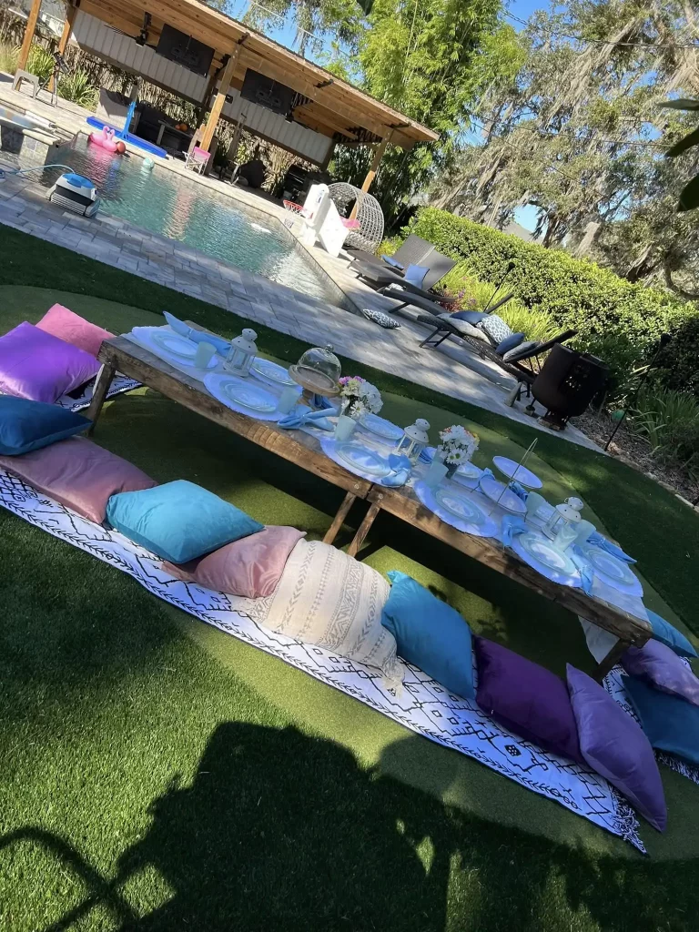 An Ultimate Movie Night Setup Training Package - Transform Your Events set up on the grass in front of a pool.