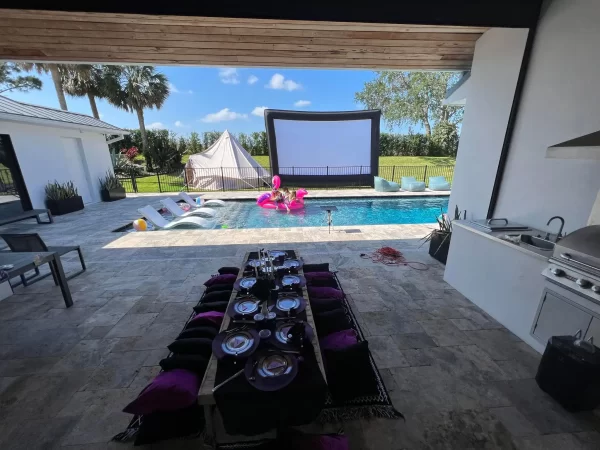 A backyard with a pool and the Ultimate Movie Night Setup Training Package - Transform Your Events.