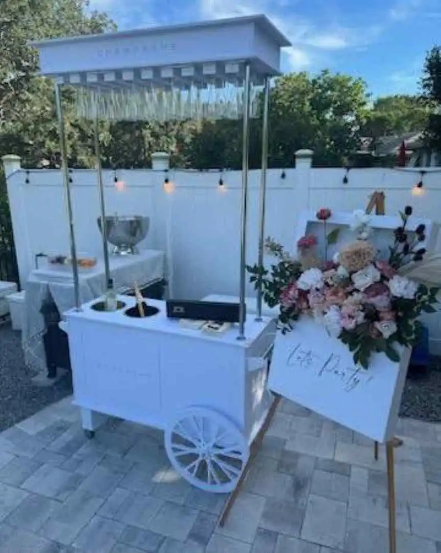 A white cart with flowers and the Ultimate Movie Night Setup Training Package - Transform Your Events.