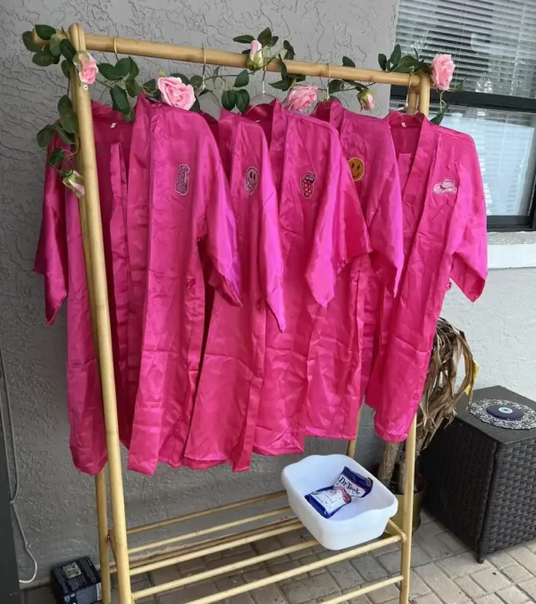 Ultimate Movie Night Setup Training Package - Transform Your Events with pink robes hanging on a rack.